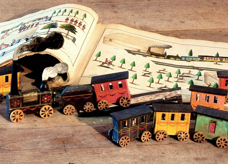 Spielzeugeisenbahn und Musterbuch um 1870