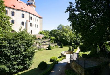 Sommerliche Aufnahme einer Parkanlage vor den Mauern eines Schlosses
