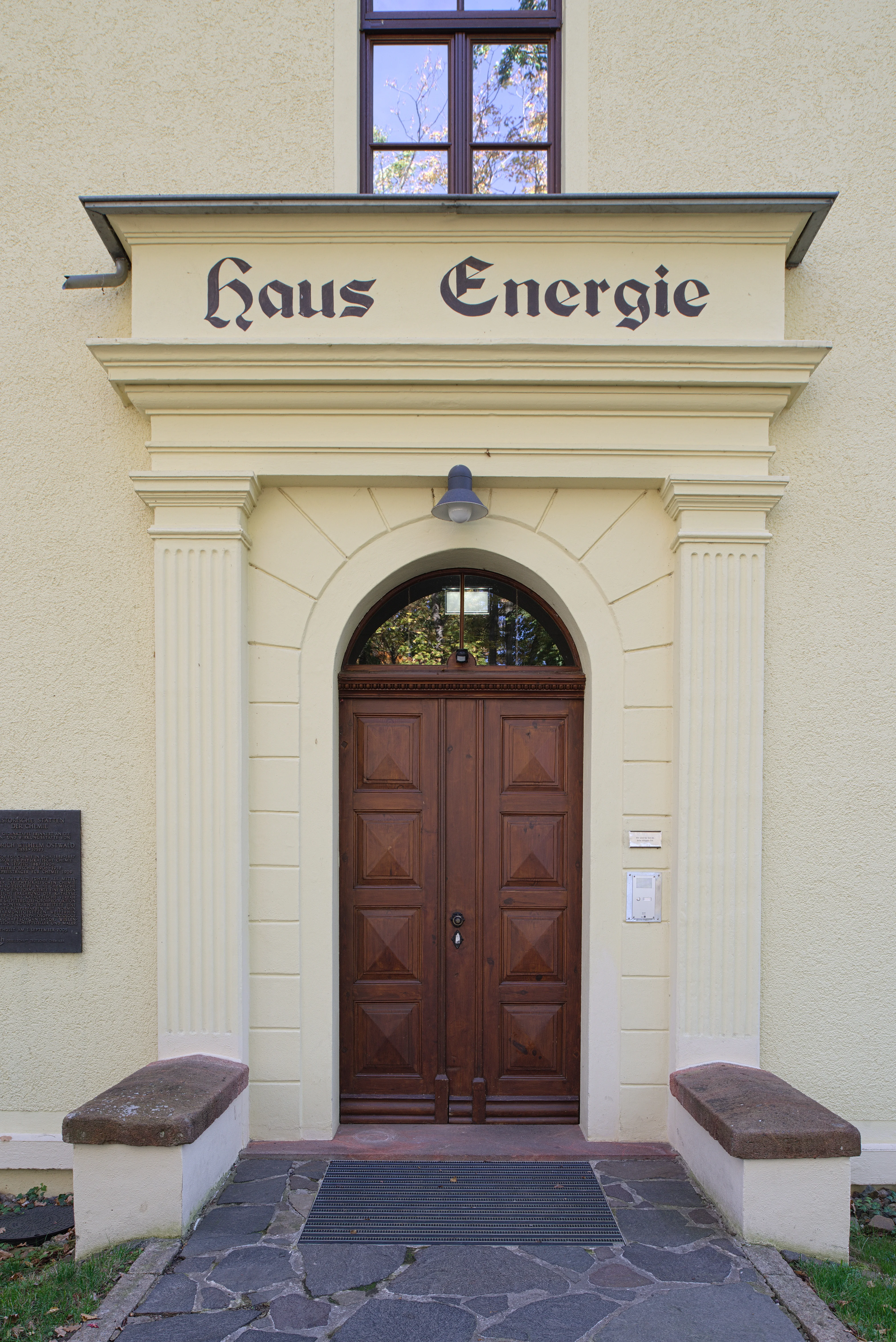 Eingang zum Haus Energie im Wilhelm Ostwald Park Portal eines Gründerzeitgebäudes mit neoklassizistischen Säulen zu beiden Seiten der Holztür und der Inschrift "Haus Energie"