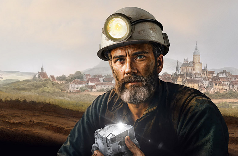 Das Bild zeigt einen Bergmann, der einen Helm mit einer Stirnlampe trägt und ein Stück Metall in den Händen hält.