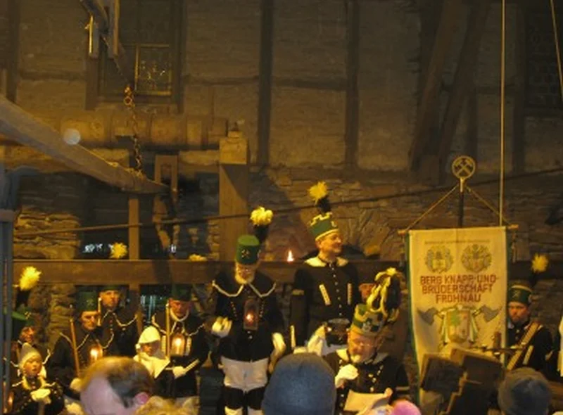 Erzgebirgische Bergleute in traditioneller Uniform feiern im historischen Frohnauer Hammer eine Mettenschicht.