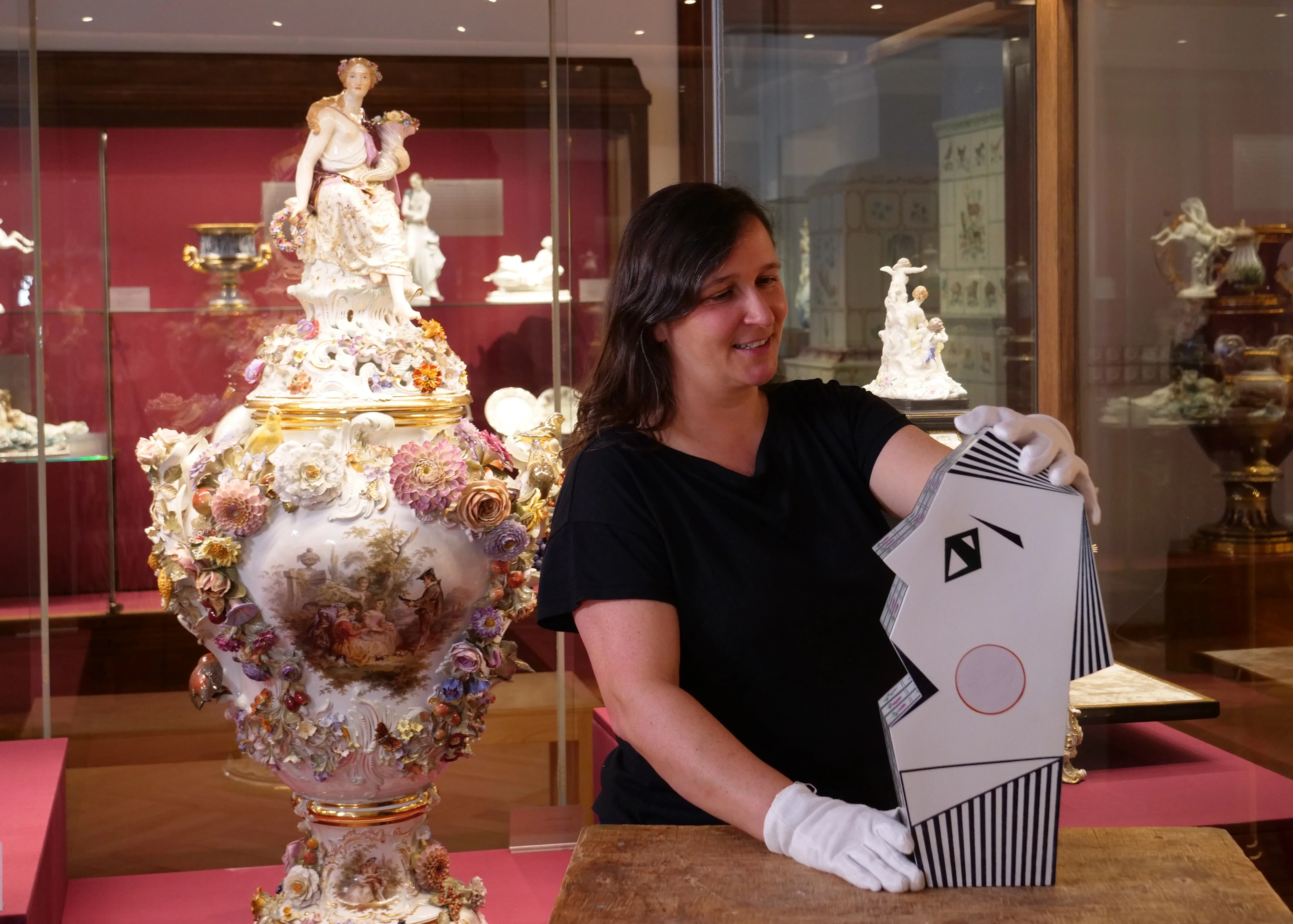 Kuratorenführung im Museum Eine Kuratorin erläutert im Museum der Meissen Porzellan-Stiftung ein opulent dekoriertes Porzellanobjekt.