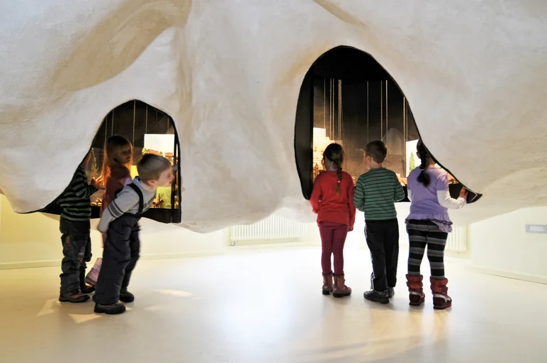 Das Foto zeigt sechs Kinder, die die Manufaktur der Träume entdecken.