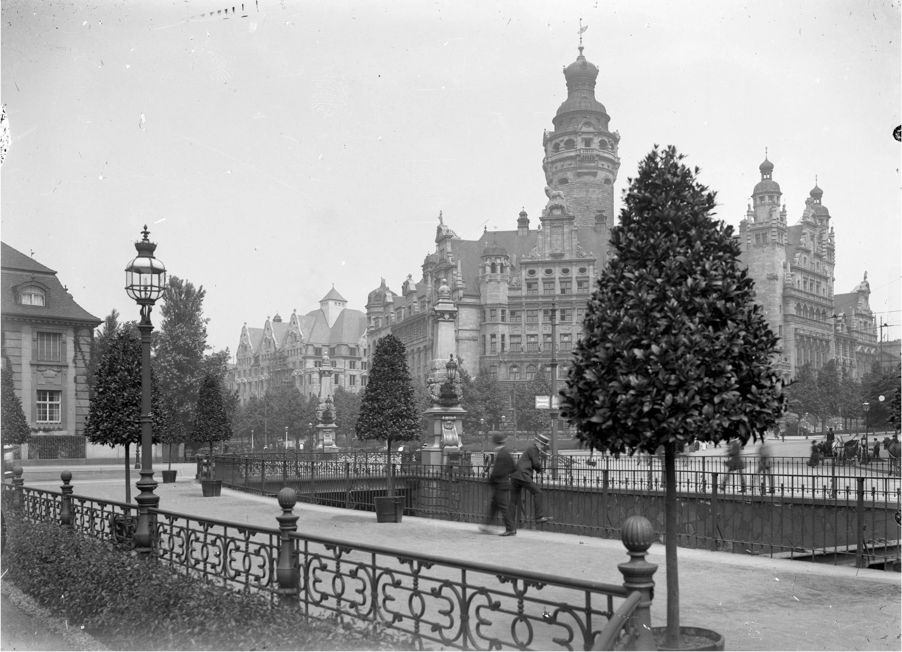 Paul Wolff, Blick über den Rathausring auf das Neue Rathaus, Leipzig, um 1915 Historische Schwarzweiß-Fotografie mit Blick auf das Leipziger Rathaus mit seinem prominenten Turm, davor zwei Spaziergänger
