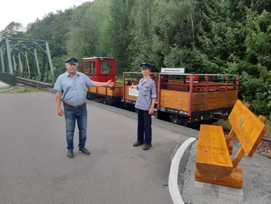 Das Zugpersonal steht in Neuschweizerthal vor dem Zug und lädt zur Mitfahrt ein.