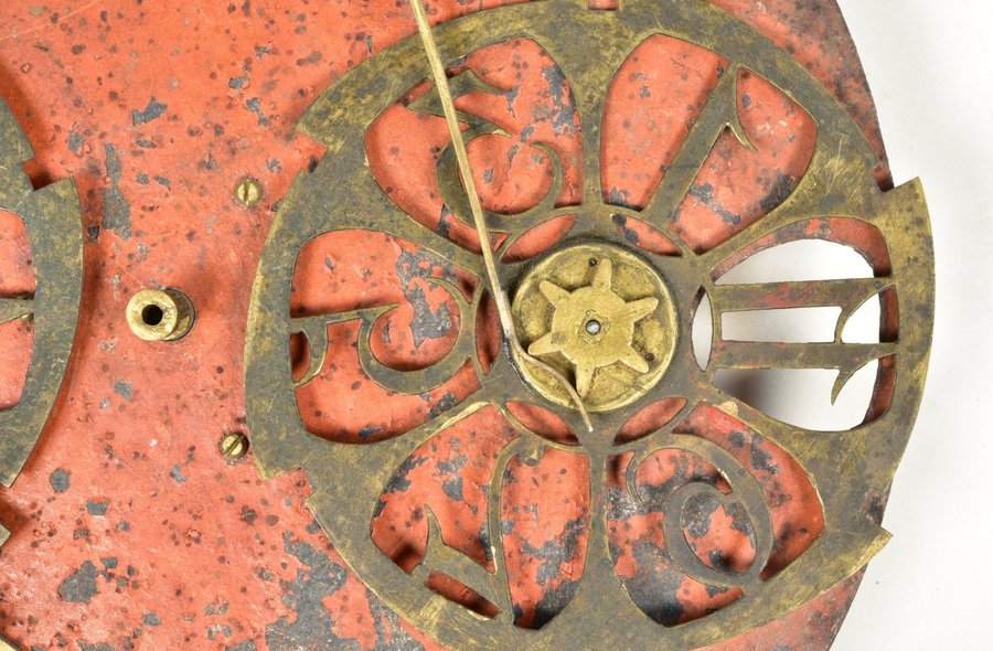 Detailaufnahme eines goldfarbenen Ziffernrades einer historischen Uhr
