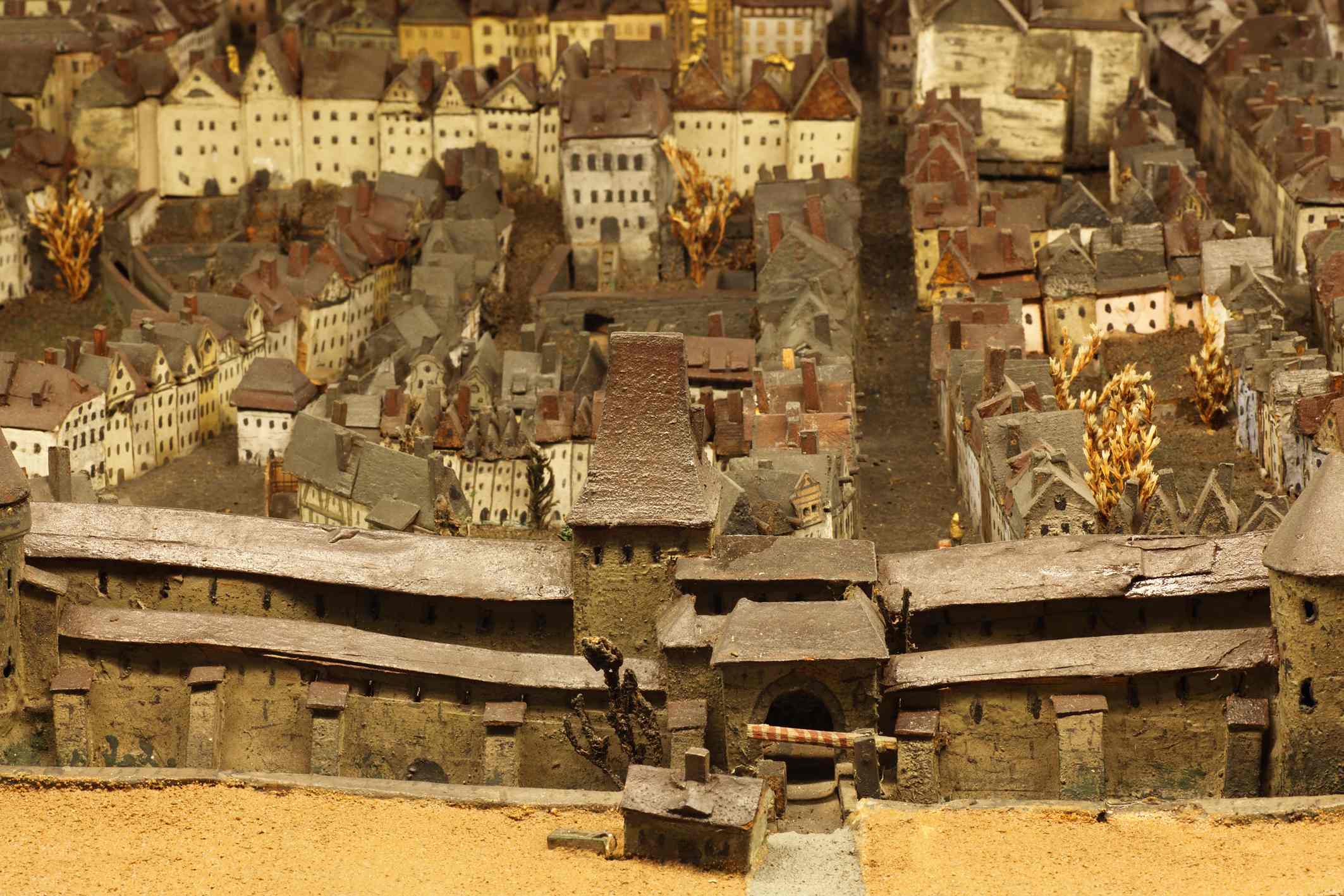 Draufsicht auf eine Miniatur der mittelalterlichen Stadt mit Stadtmauer, engen Gassen und dicht gedrängten Häusern